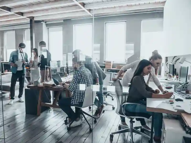 Group of young business people working and communicating together in creative office